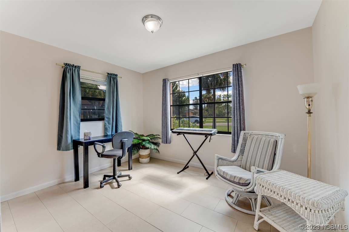 17 Pelican Drive Edgewater, FL 32141 - Photo 16 of 32 a view of a room with gym equipment and windows