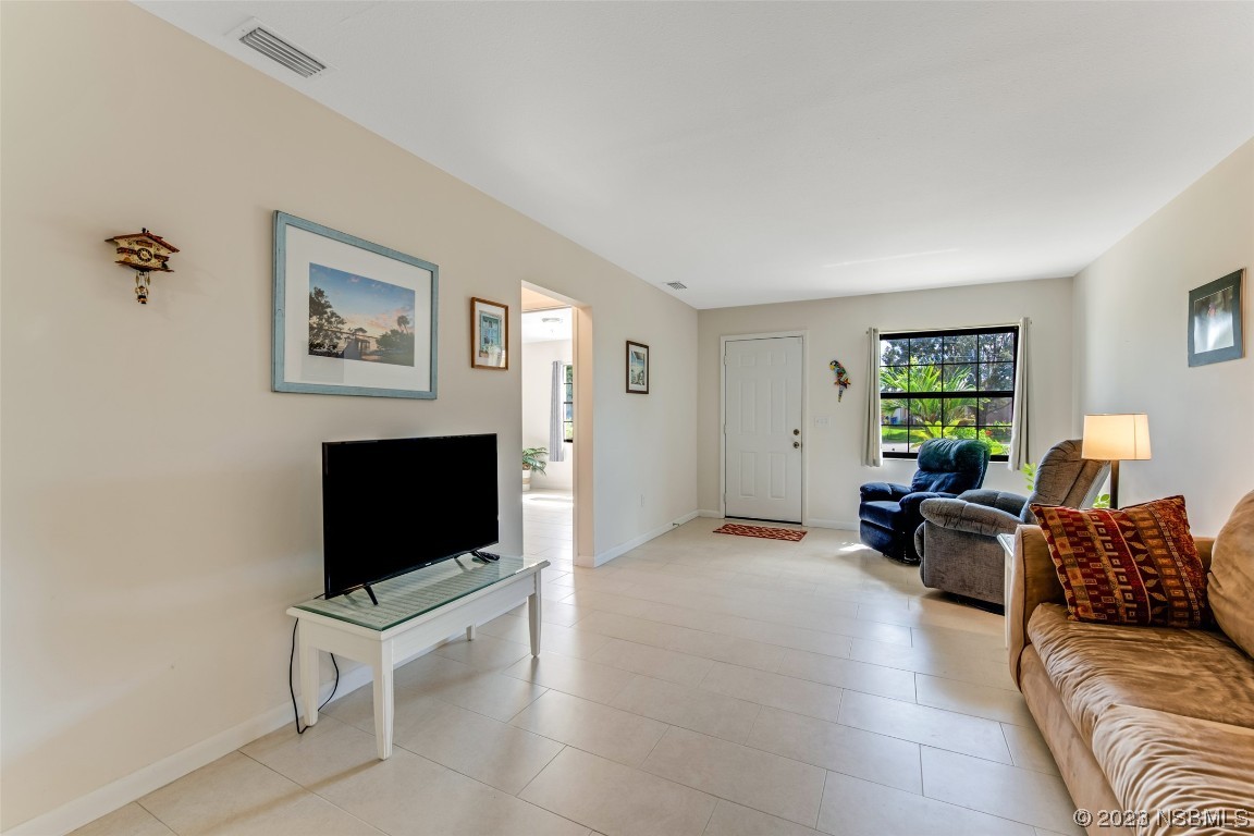 17 Pelican Drive Edgewater, FL 32141 - Photo 4 of 32 a living room with furniture and a flat screen tv