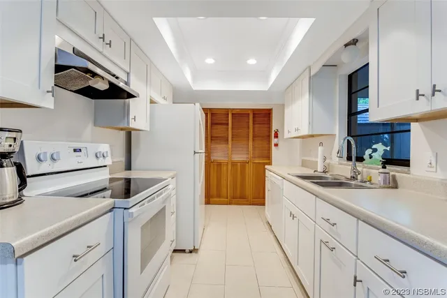 a kitchen with stainless steel appliances granite countertop a sink and a stove