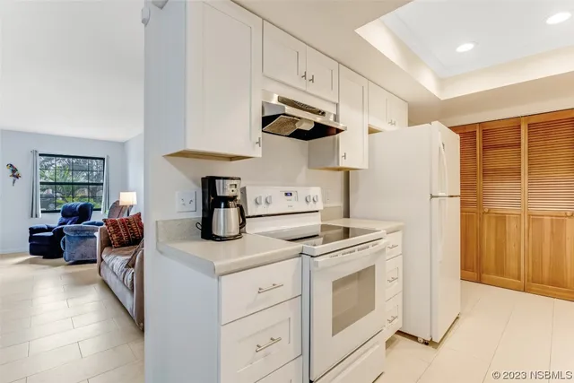 a kitchen with stainless steel appliances a stove a refrigerator and cabinets