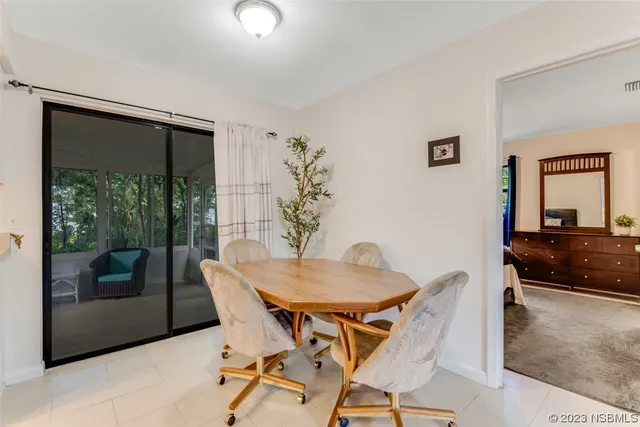 a view of a dining room with furniture and front door