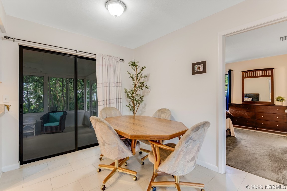 17 Pelican Drive Edgewater, FL 32141 - Photo 9 of 32 a view of a dining room with furniture and front door