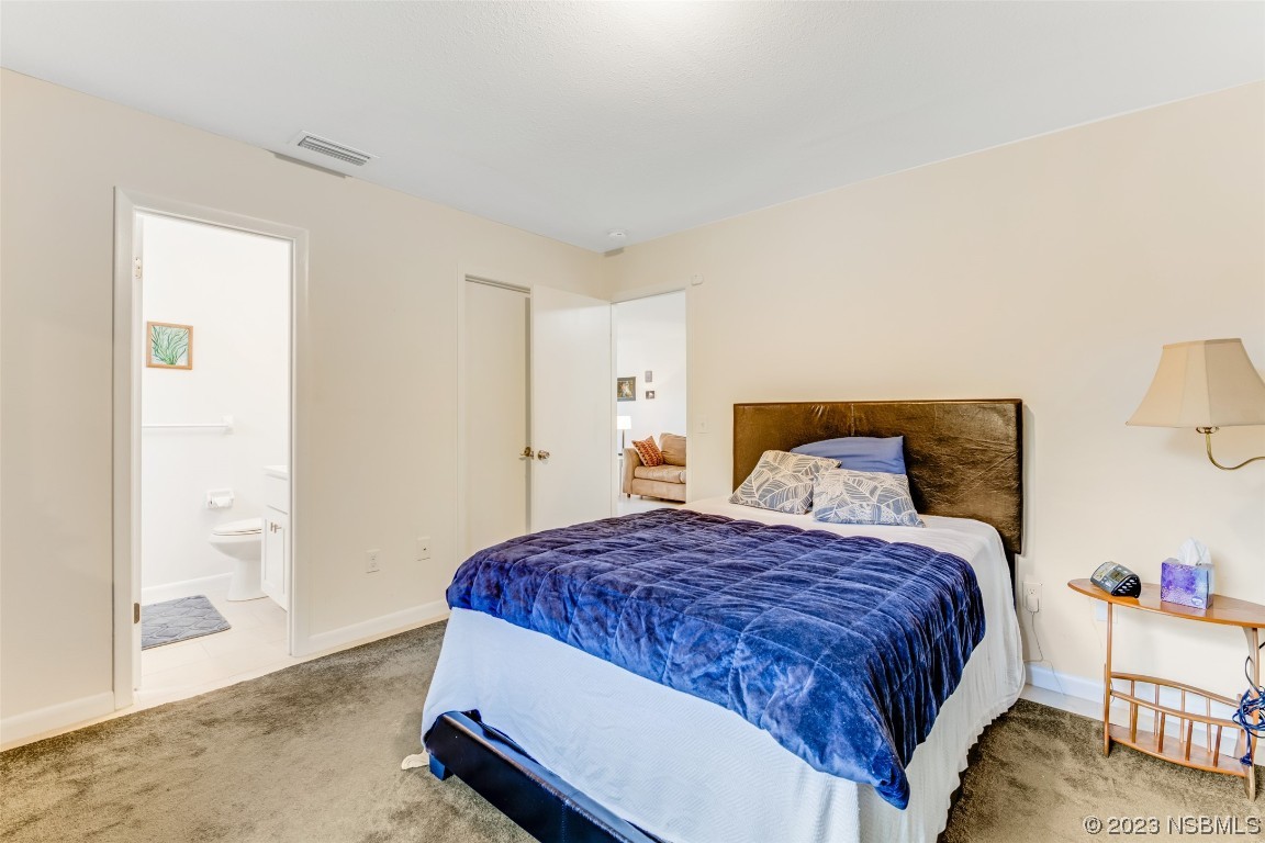 17 Pelican Drive Edgewater, FL 32141 - Photo 10 of 32 a spacious bedroom with a bed and a cabinets