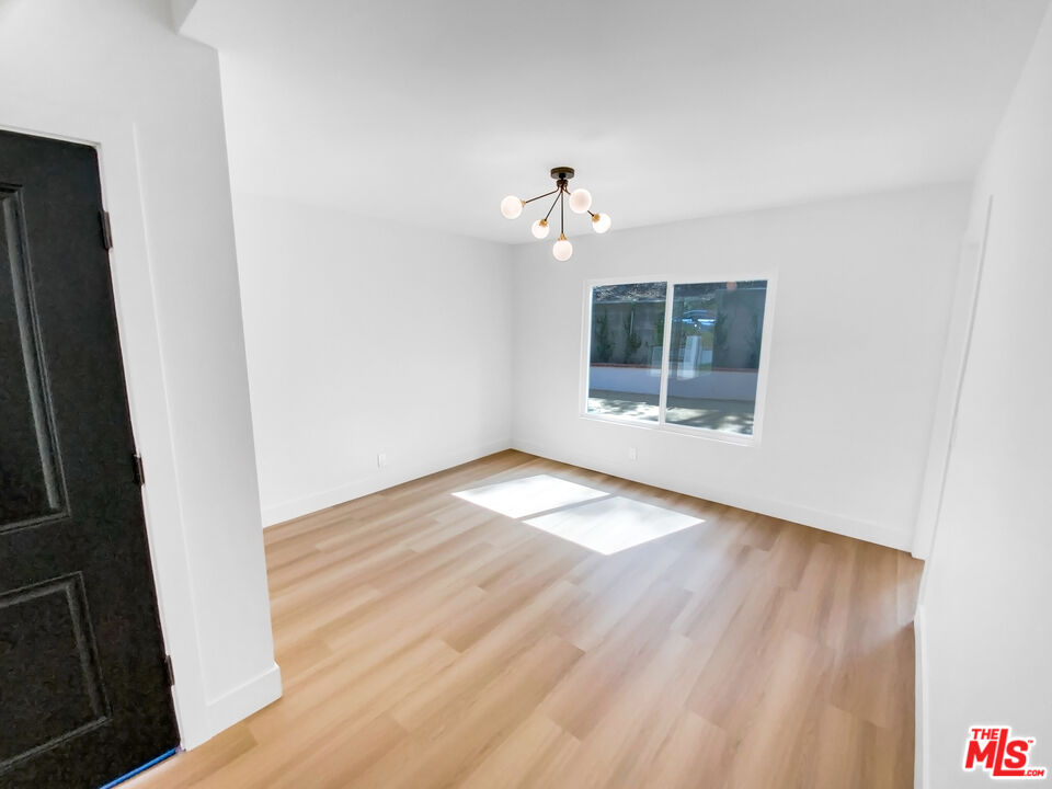 830 Vía Alameda San Dimas, CA 91773 - Photo 12 of 31 an empty room with wooden floor and windows