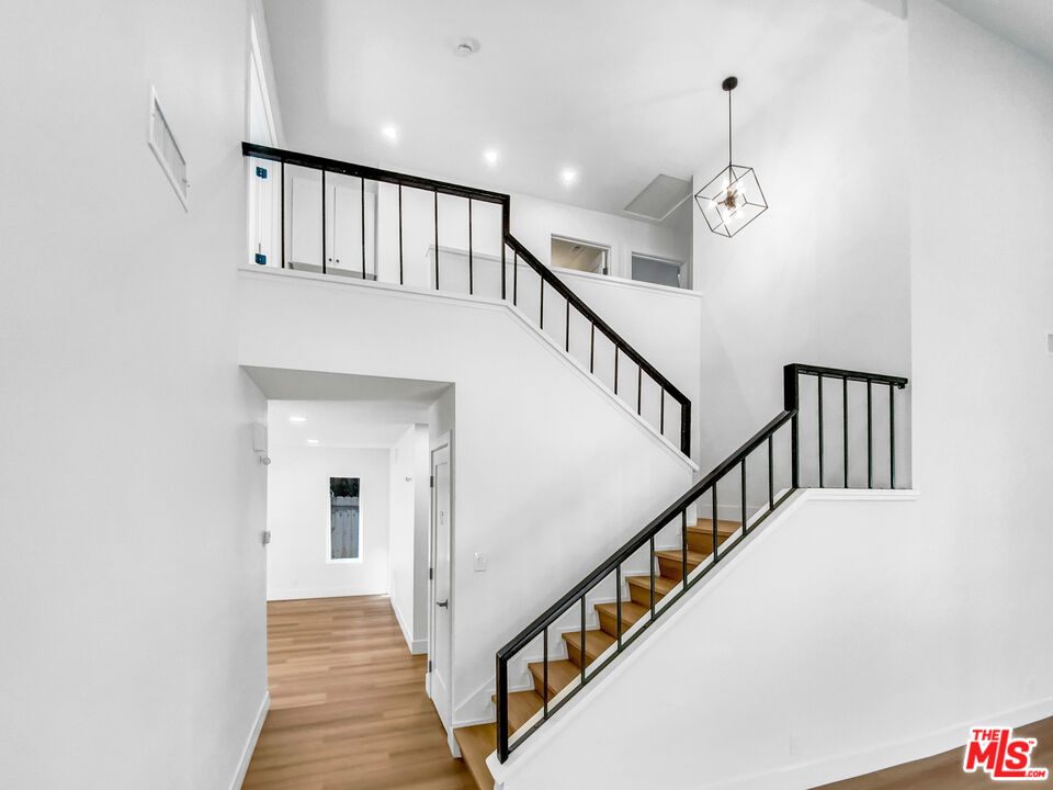 830 Vía Alameda San Dimas, CA 91773 - Photo 19 of 31 a view of staircase with lots of frames and a wooden floor