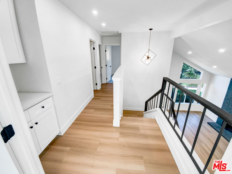 830 Vía Alameda San Dimas, CA 91773 - Photo 20 of 31 a view of a hallway with wooden floor and stairs