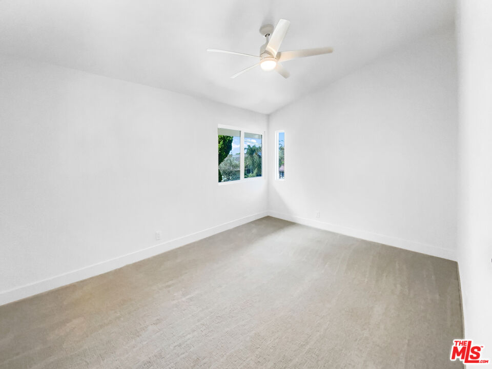 830 Vía Alameda San Dimas, CA 91773 - Photo 5 of 31 an empty room with windows and ceiling fan view