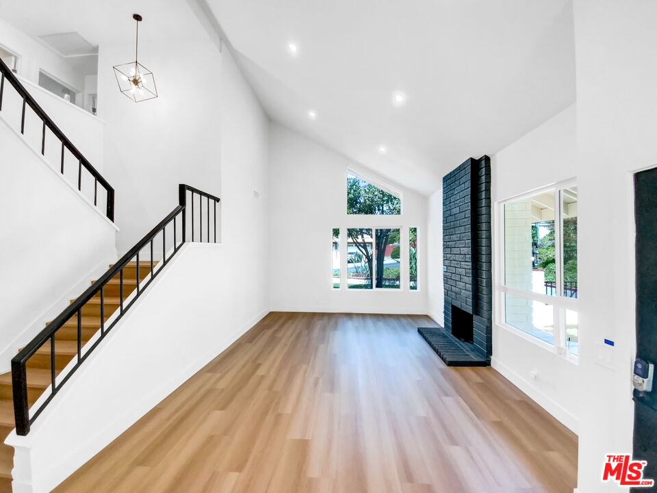 830 Vía Alameda San Dimas, CA 91773 - Photo 10 of 31 a view of an empty room with wooden floor and a window