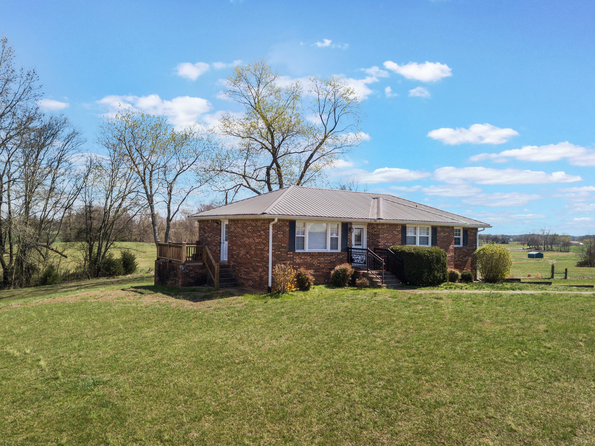 6035 Buzzard Creek Road Cedar Hill, TN 37032 - Photo 1 of 42 a view of a house with a yard and sitting area
