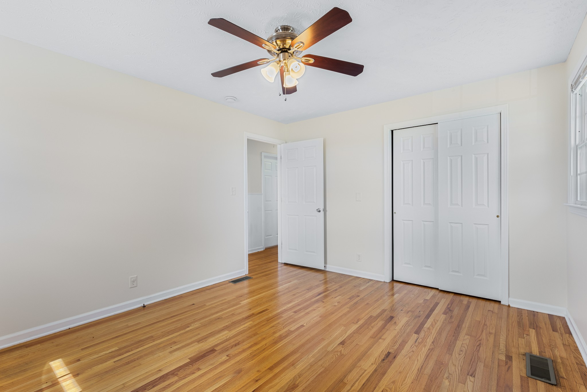 6035 Buzzard Creek Road Cedar Hill, TN 37032 - Photo 17 of 42 an empty room with wooden floor and ceiling fan