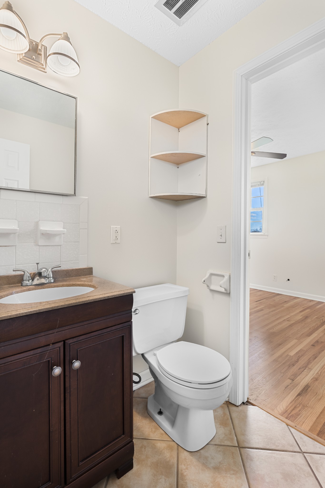 6035 Buzzard Creek Road Cedar Hill, TN 37032 - Photo 23 of 42 a bathroom with a toilet a sink and mirror