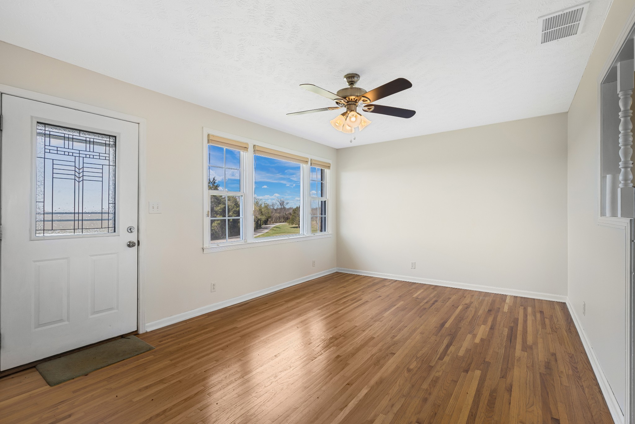 6035 Buzzard Creek Road Cedar Hill, TN 37032 - Photo 8 of 42 a view of empty room with wooden floor and fan