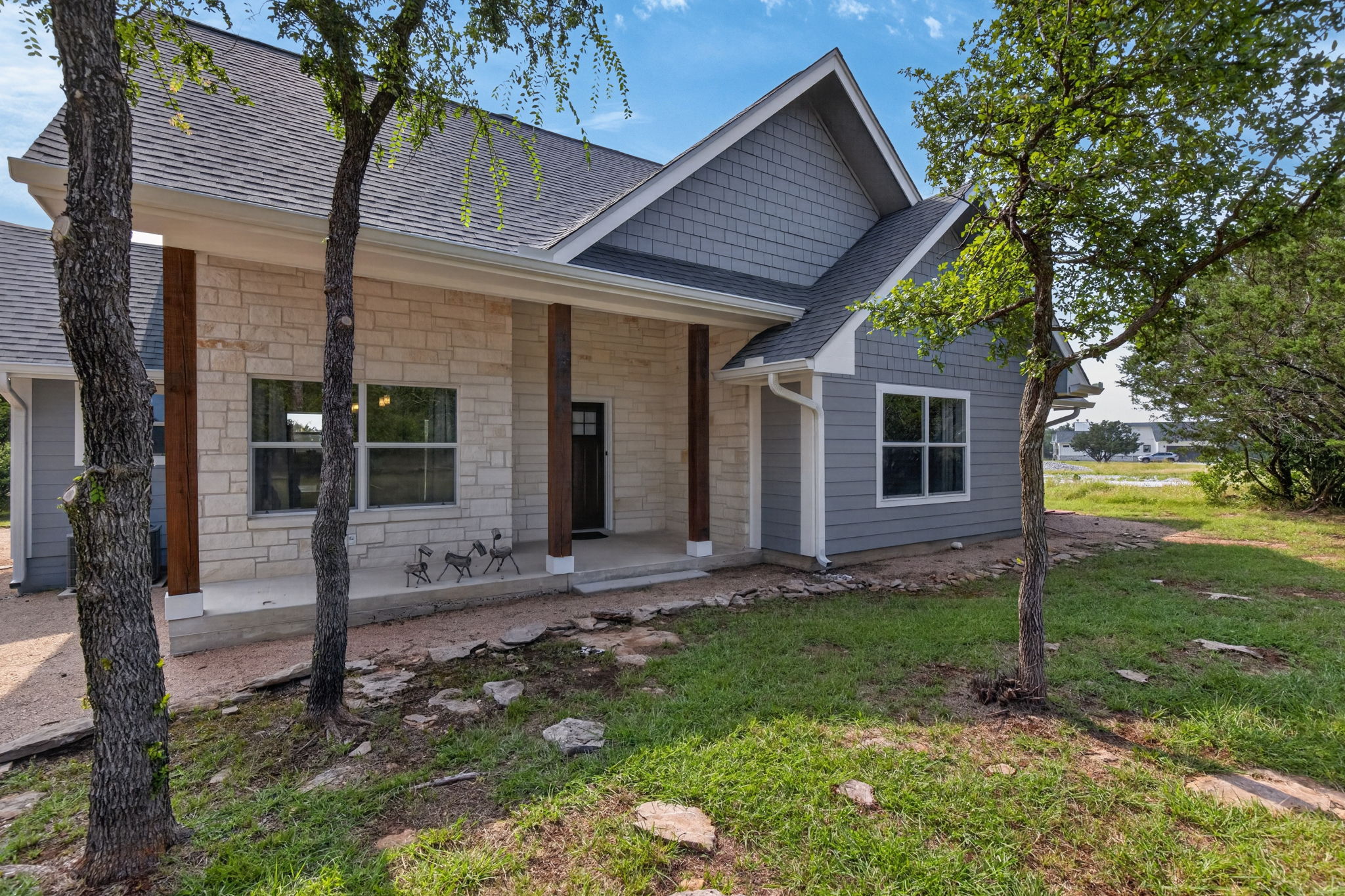 207 Deer Ridge Drive Burnet, TX 78611 - Photo 2 of 36 A welcoming stone and siding facade offers a pleasant curb appeal.