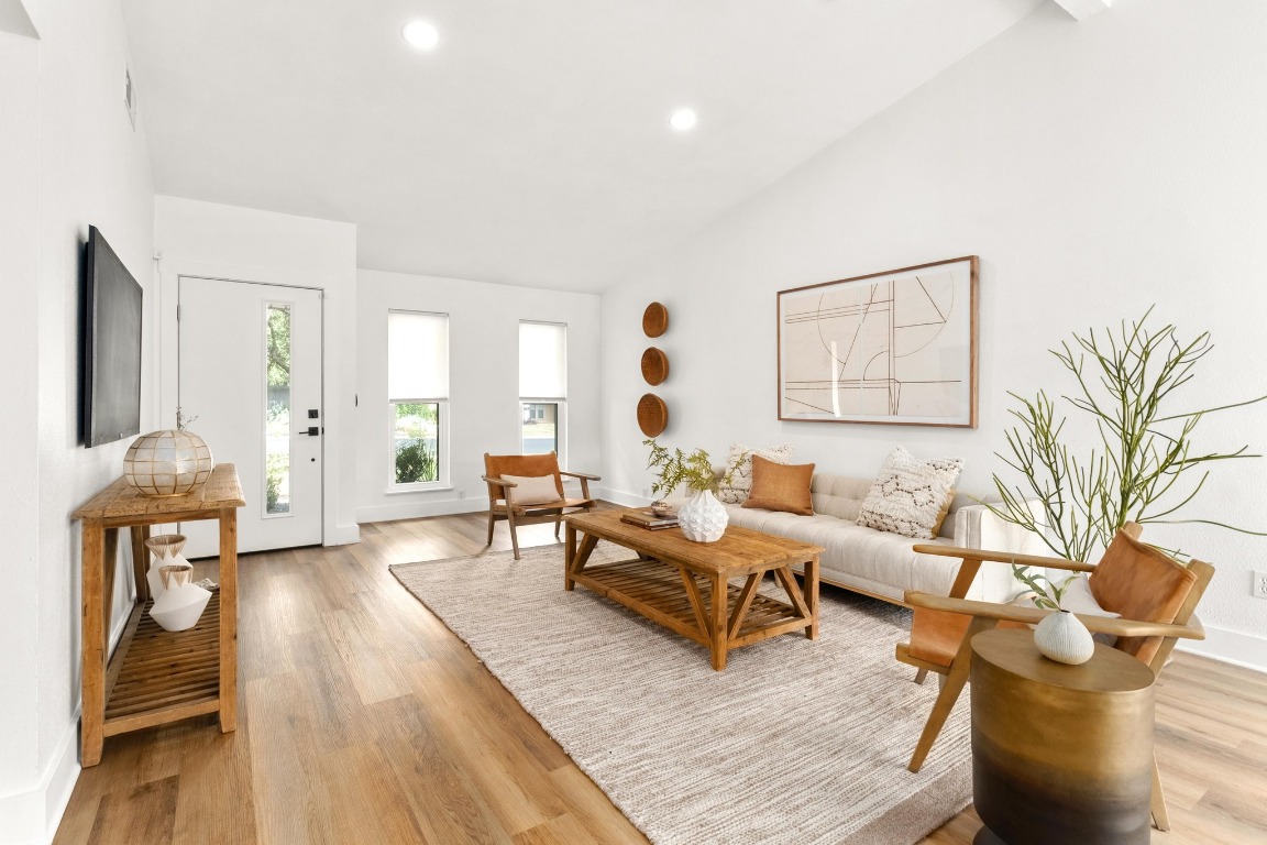 8907 Hunters Trace Austin, TX 78758 - Photo 1 of 1 Living area with light wood-style floors, recessed lighting, and high vaulted ceiling