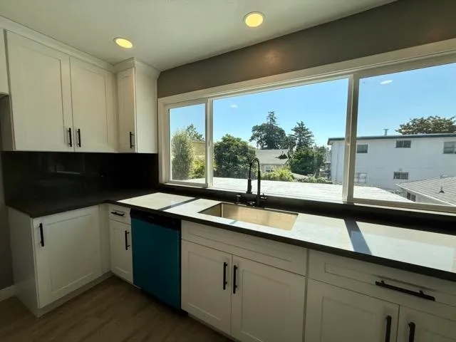 a kitchen with a sink and large window