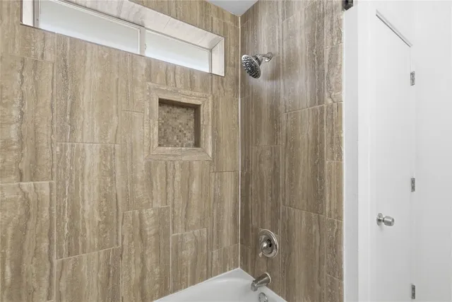 a bathroom with a shower and a sink