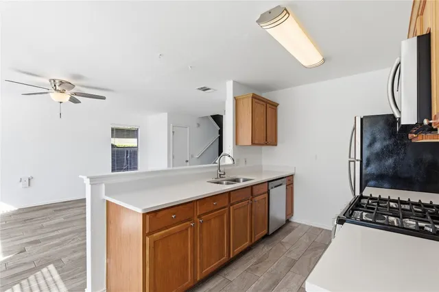 a kitchen with a sink a stove and cabinets