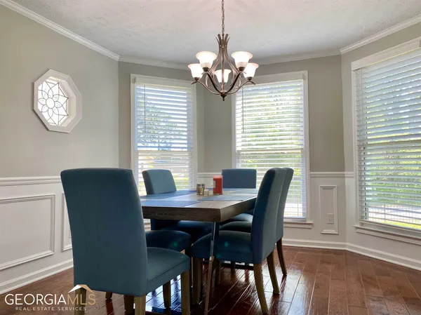 a dining room with furniture and window