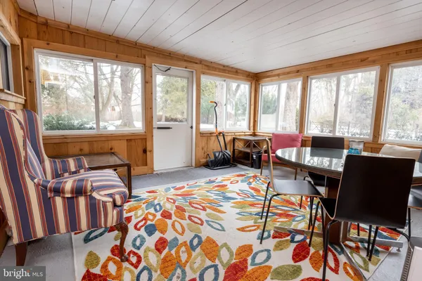 a bedroom with furniture and large windows