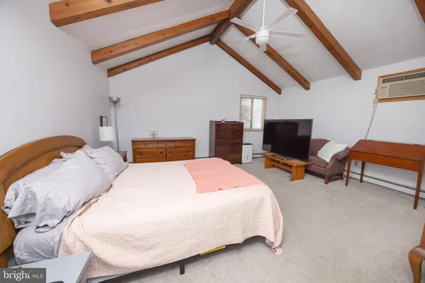 a bedroom with a bed and a television