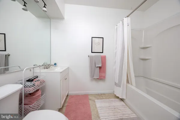 a bathroom with a sink toilet vanity and bathtub