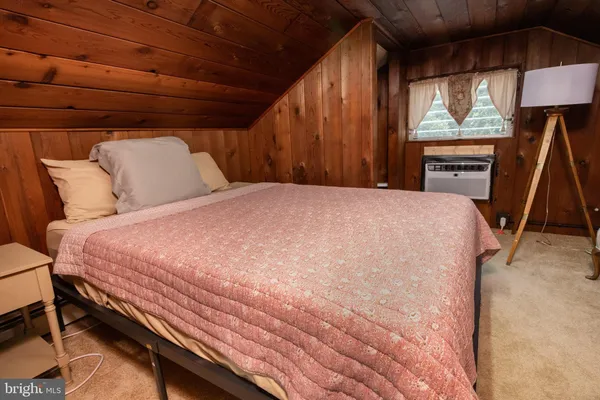 a bed sitting in a bedroom next to a window