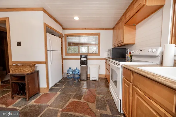 a kitchen with a sink a counter top space and stainless steel appliances
