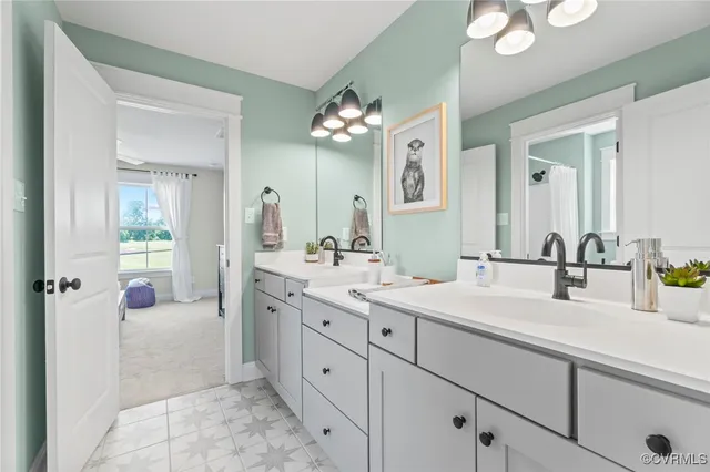 a spacious bathroom with a granite countertop sink mirror and a