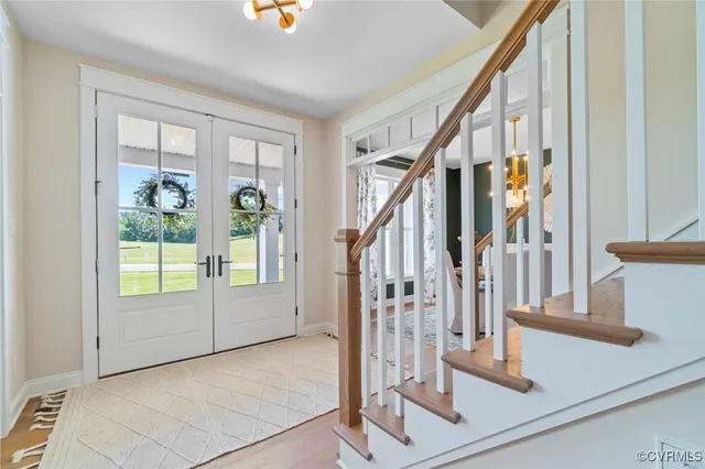 a view of an entryway with wooden floor and door