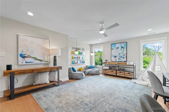a living room with furniture and a wooden floor
