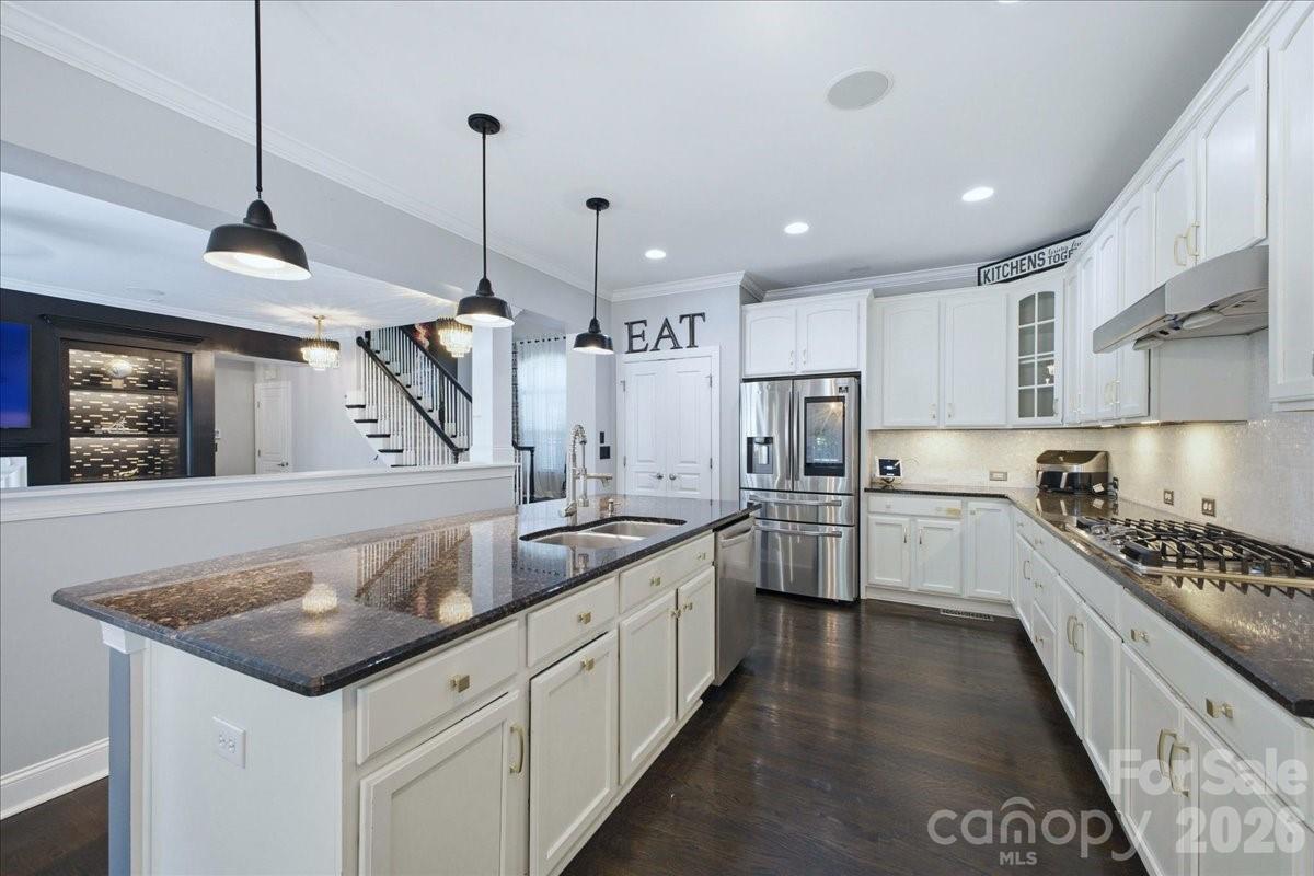 1825 Laveta Road Charlotte, NC 28269 - Photo 14 of 48 a kitchen with stainless steel appliances granite countertop a sink stove and refrigerator