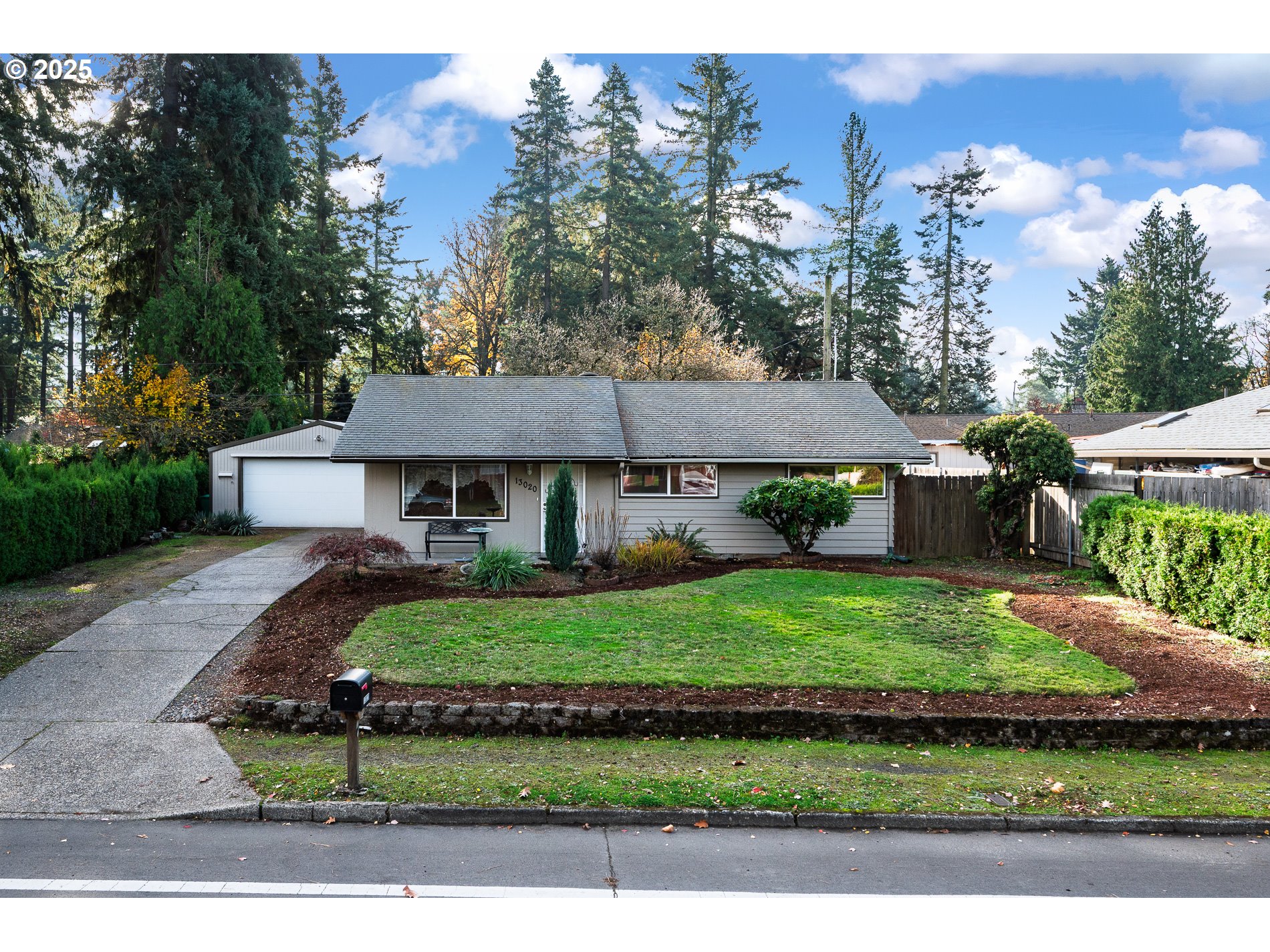 13020 Northeast San Rafael Street Portland, OR 97230 - Photo 2 of 35 a view of a white house with a yard and potted plants