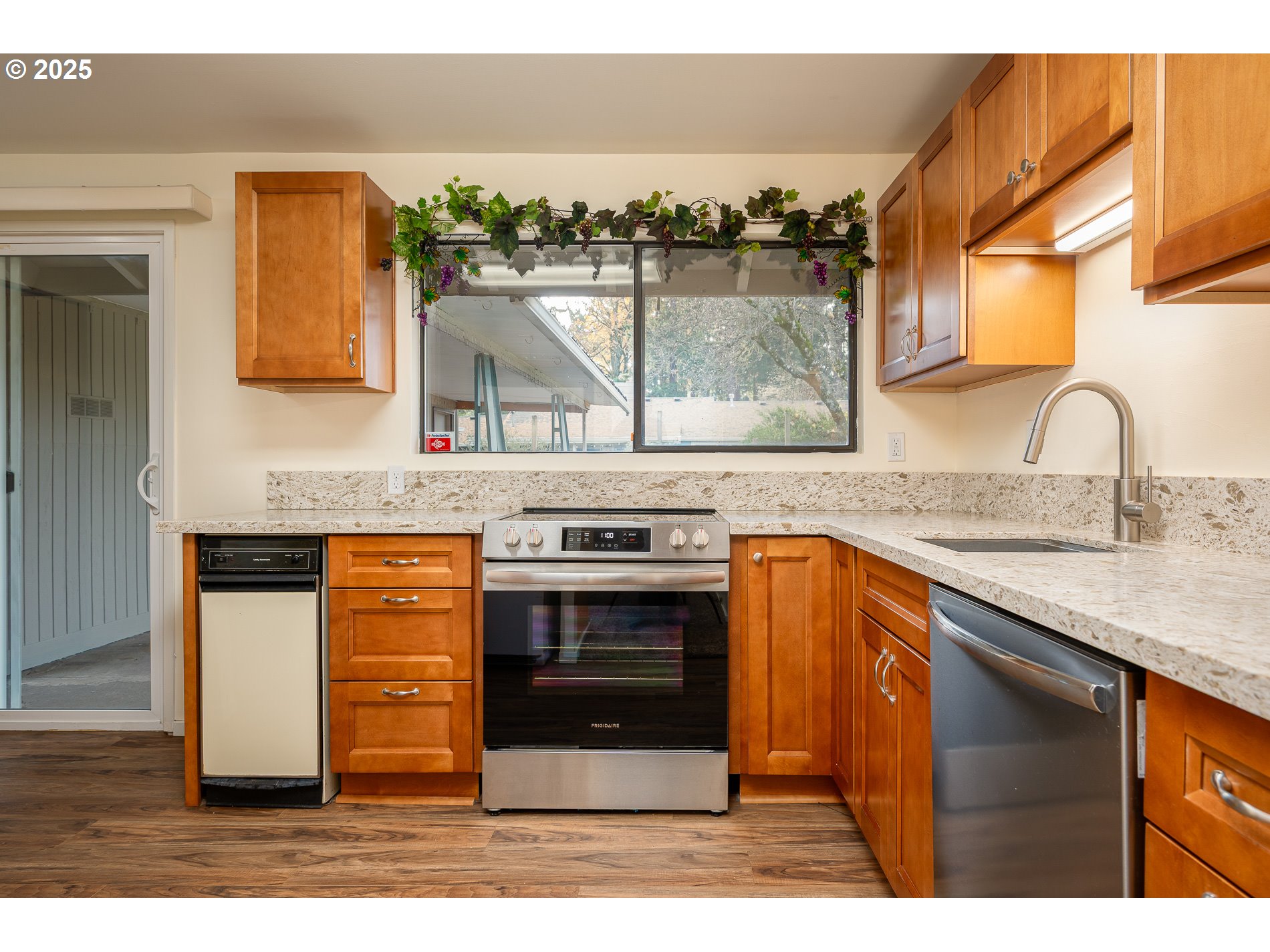 13020 Northeast San Rafael Street Portland, OR 97230 - Photo 6 of 35 a kitchen with stainless steel appliances granite countertop a sink and a stove