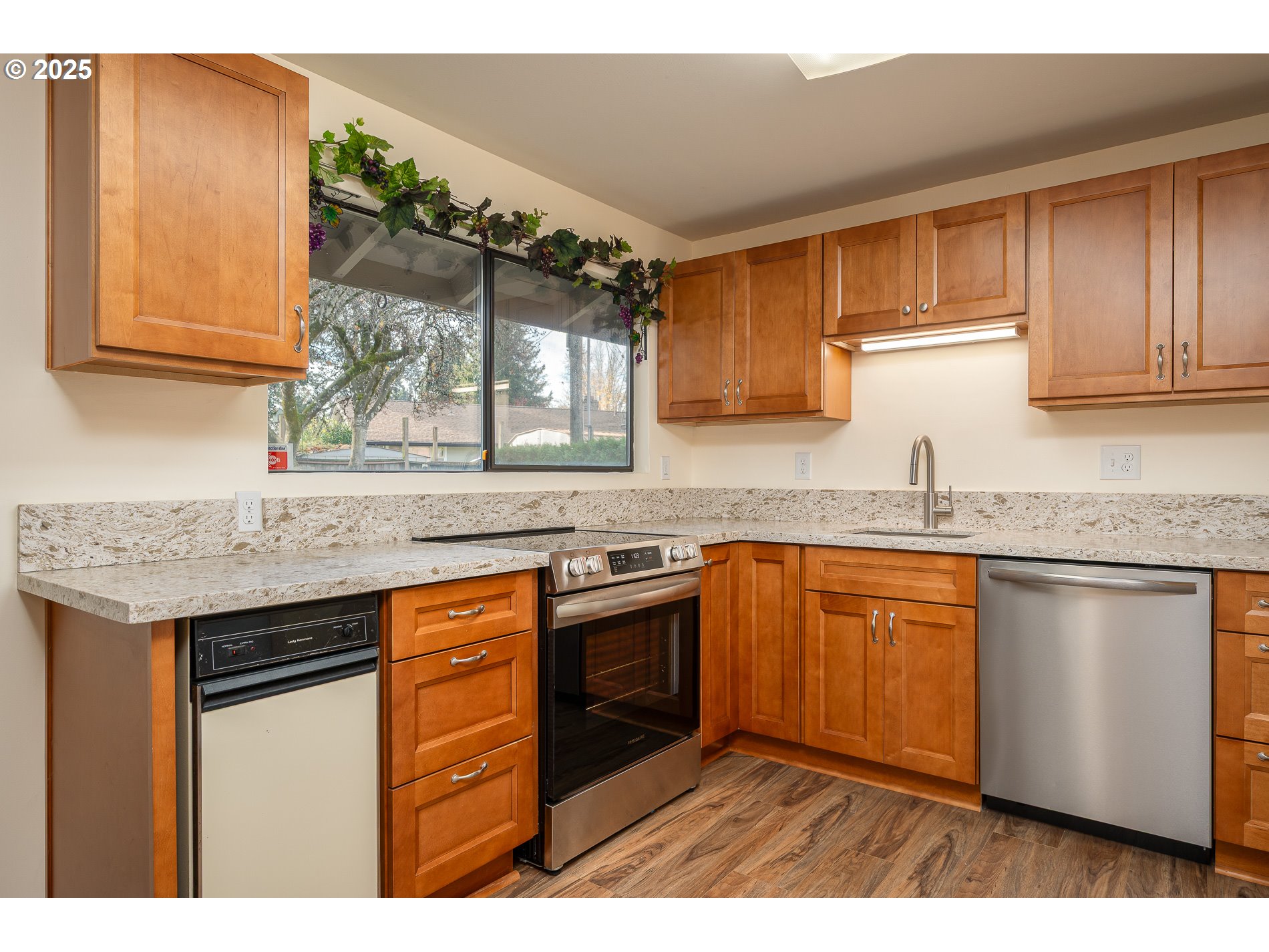 13020 Northeast San Rafael Street Portland, OR 97230 - Photo 9 of 35 a kitchen with stainless steel appliances granite countertop a sink stove and refrigerator