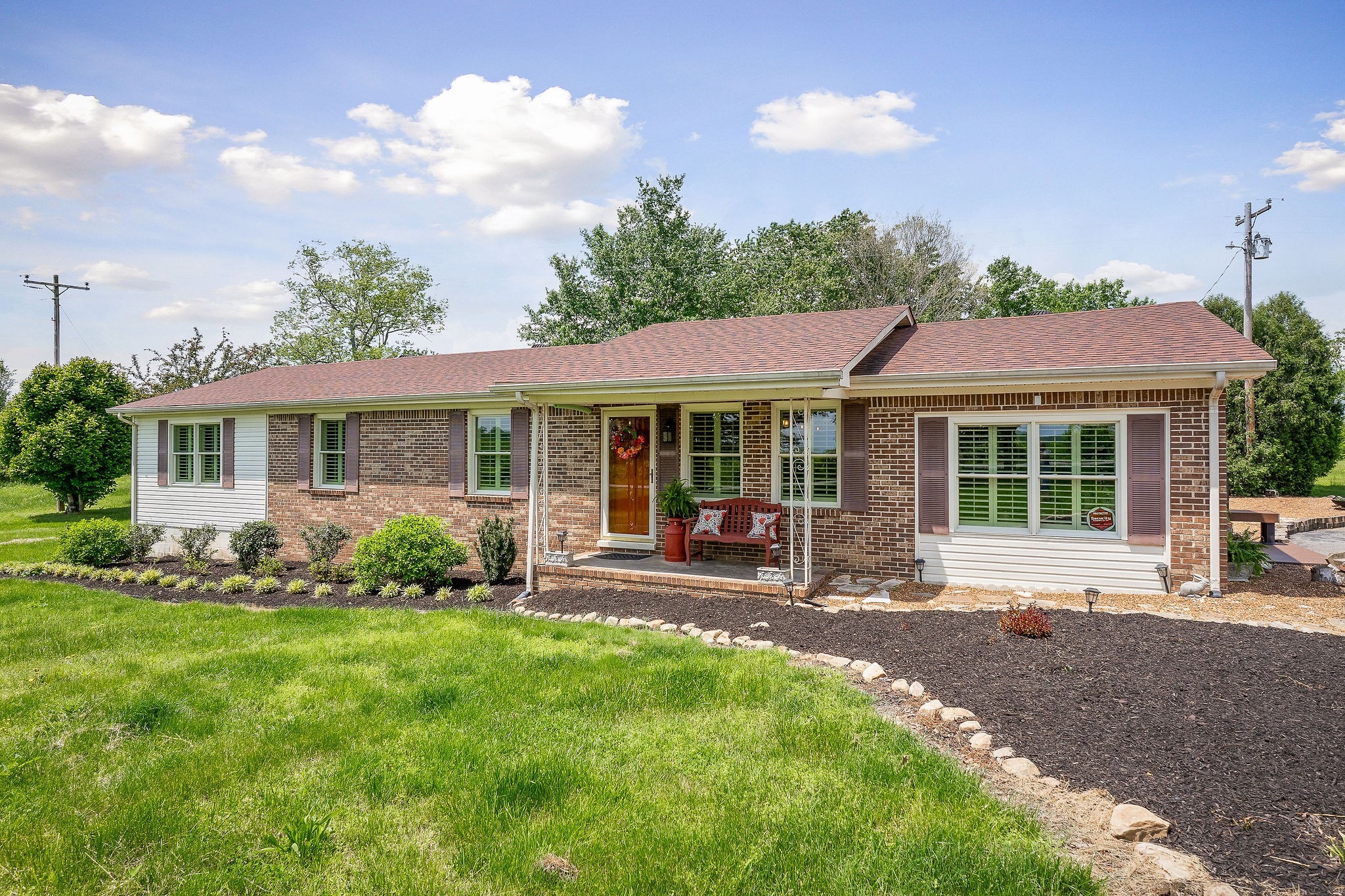 a front view of a house with a garden and patio