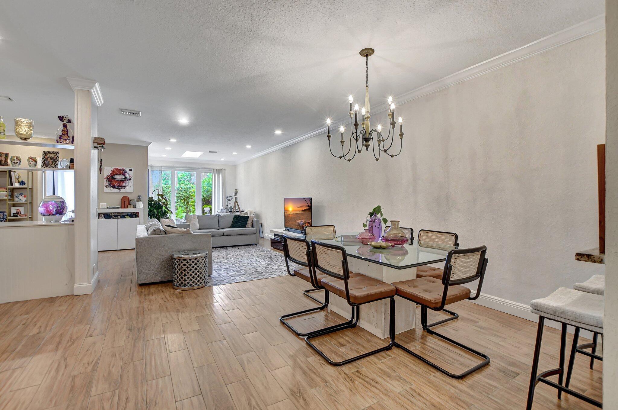 6682 Via Regina Boca Raton, FL 33433 - Photo 5 of 46 a living room with furniture and a chandelier