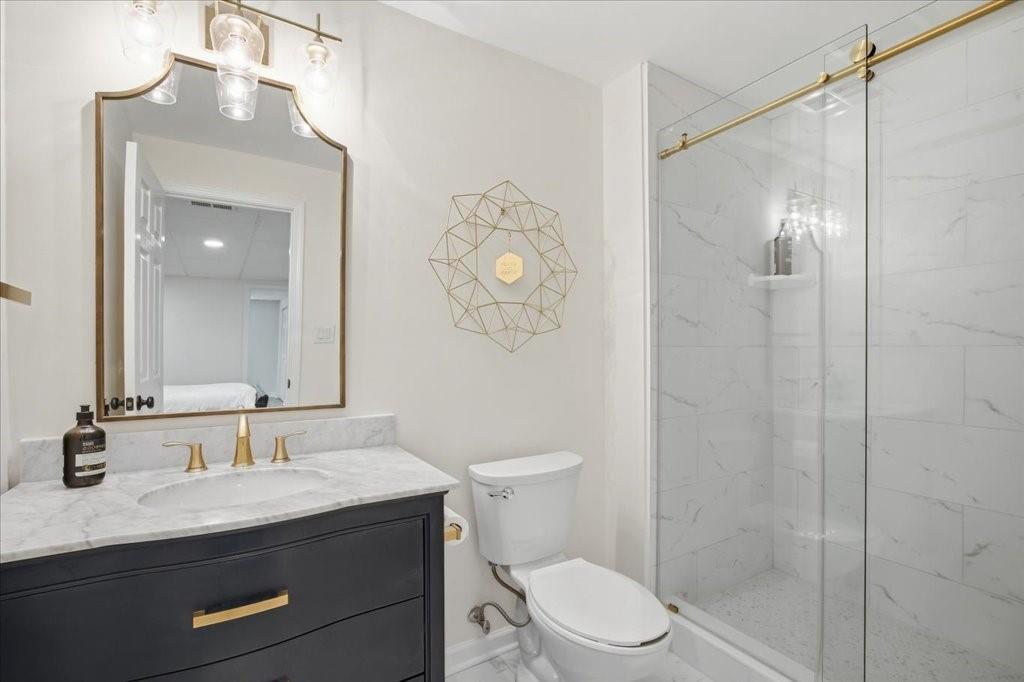 397 Thomas Road Dallas, GA 30132 - Photo 69 of 108 a bathroom with a granite countertop sink toilet a mirror a vanity and shower