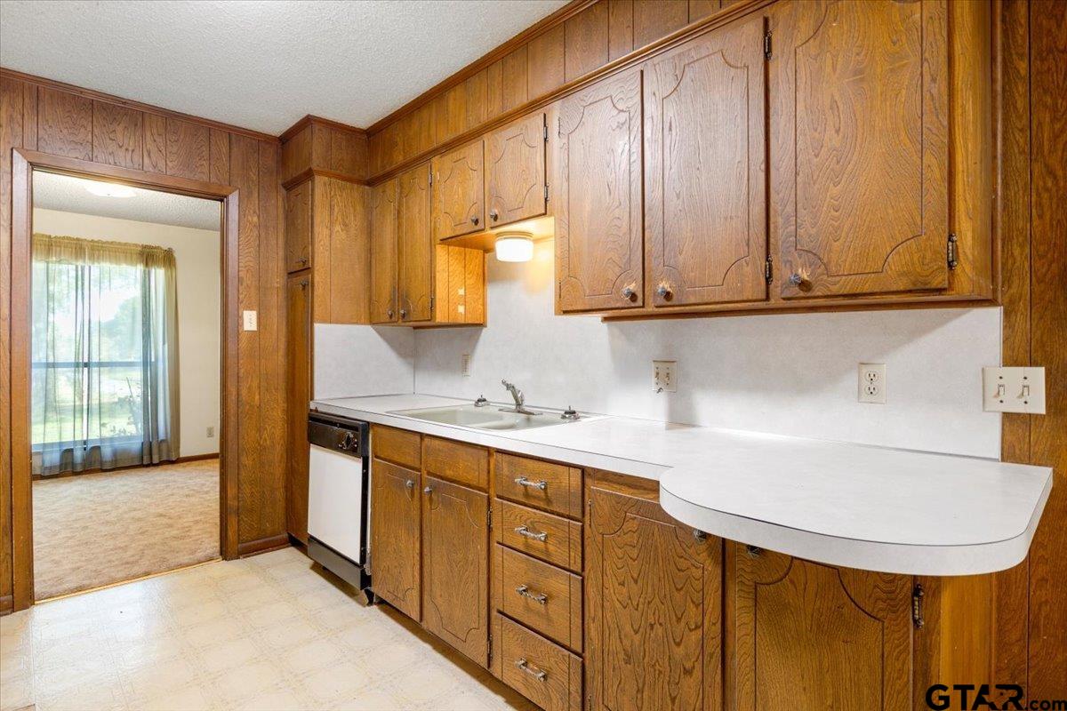 1302 Jeb Stuart Drive Tyler, TX 75703 - Photo 10 of 47 a kitchen with stainless steel appliances a sink and cabinets