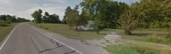 a view of a road with a yard
