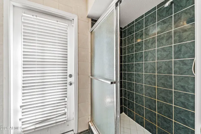 a bathroom with a window and a shower