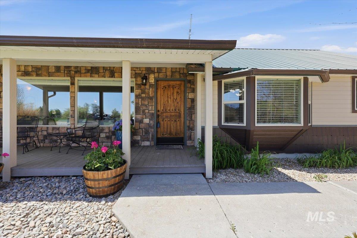 18105 Plum Road Caldwell, ID 83607 - Photo 8 of 45 Enjoy Morning Coffee from Your Covered Front Porch with Trex Decking.
