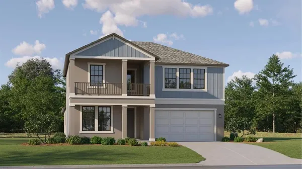 a front view of a house with a yard and trees