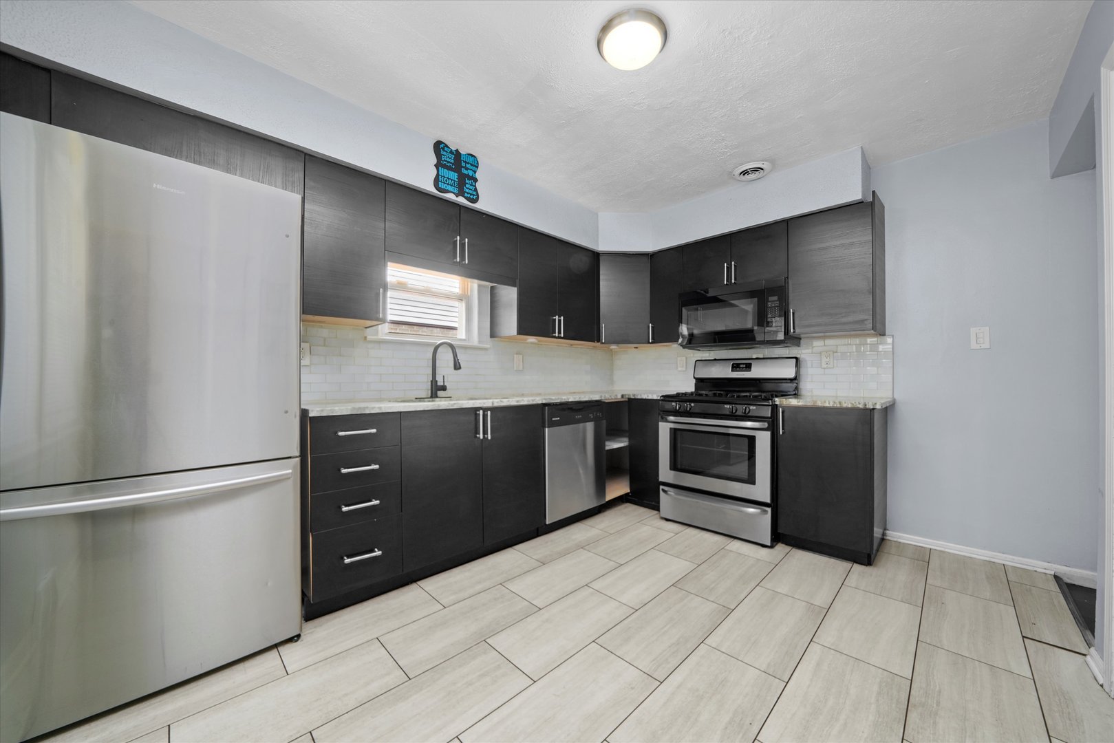 706 North Main Street Mount Prospect, IL 60056 - Photo 5 of 14 a kitchen with granite countertop a refrigerator and a stove top oven