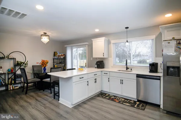 a kitchen with appliances a sink and cabinets