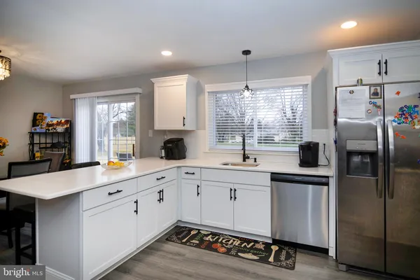 a kitchen with stainless steel appliances a refrigerator sink and cabinets