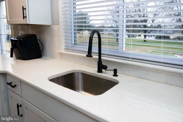 a kitchen with a sink and a window