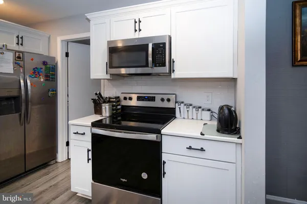 a kitchen with a stove and a microwave