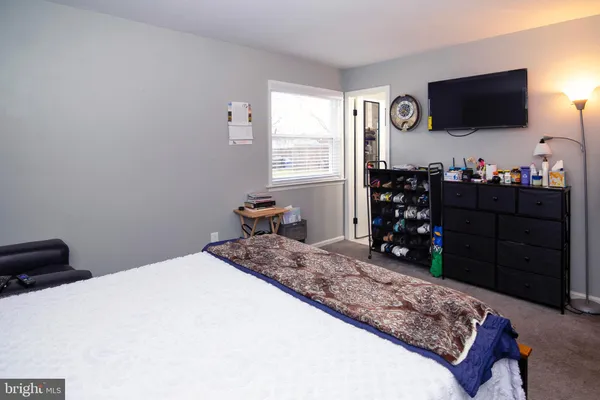 a bedroom with a bed and flat screen tv