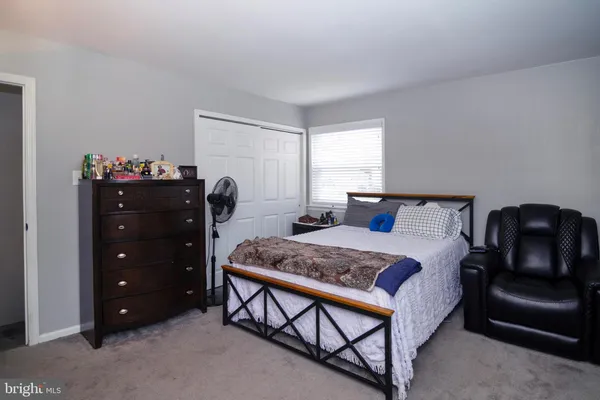 a bedroom with a bed and a closet