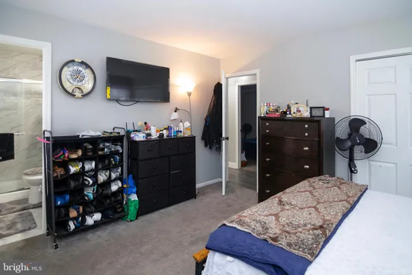 a bedroom with a bed and a television